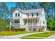 Two story farmhouse style home with gray accents and a large yard at 1480 Jeremy Cay Ct, Awendaw, SC 29429