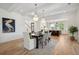 Elegant dining room with a large table and kitchen views at 1480 Jeremy Cay Ct, Awendaw, SC 29429