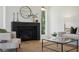 Modern fireplace with dark stone mantel and a glass coffee table in front at 1480 Jeremy Cay Ct, Awendaw, SC 29429