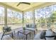 Covered porch with wooden floors, seating, and wooded views at 1480 Jeremy Cay Ct, Awendaw, SC 29429