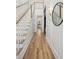 Bright entryway with hardwood floors, white walls, and a grand staircase at 1480 Jeremy Cay Ct, Awendaw, SC 29429