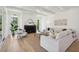 Cozy living room with hardwood floors, a fireplace, and ample natural light at 1480 Jeremy Cay Ct, Awendaw, SC 29429