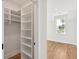 White built-in shelving and hanging space in this roomy closet at 1480 Jeremy Cay Ct, Awendaw, SC 29429