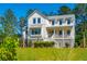 Stunning two-story farmhouse with white siding and gray accents at 1480 Jeremy Cay Ct, Awendaw, SC 29429