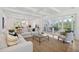 Spacious living area featuring a sectional sofa and access to a screened porch at 1480 Jeremy Cay Ct, Awendaw, SC 29429