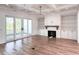 Bright living room features hardwood floors, fireplace, built-in shelving, and access to outdoor patio at 3869 Delinger Dr, Mount Pleasant, SC 29466