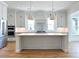 Modern kitchen with white cabinetry, large island, and stainless steel appliances at 3869 Delinger Dr, Mount Pleasant, SC 29466