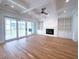 Bright living room features hardwood floors, fireplace, built-in shelving, and access to outdoor patio at 3869 Delinger Dr, Mount Pleasant, SC 29466