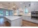Modern kitchen with white cabinetry, marble island, and gold light fixtures at 3869 Delinger Dr, Mount Pleasant, SC 29466