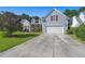 Two story house featuring a gray exterior, red shutters, and a two car garage at 399 Decatur Dr, Summerville, SC 29486