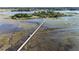 Aerial view showcasing a long boardwalk over a tranquil marsh at 3531 Old Ferry Rd, Johns Island, SC 29455