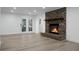 Bright living room featuring a brick fireplace and hardwood floors at 112 Huckleberry Ln, Summerville, SC 29485