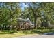 Two story brick home with red shutters and mature trees at 112 Huckleberry Ln, Summerville, SC 29485