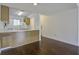 Open concept kitchen with wood cabinets, white appliances, and dark brown flooring at 809 Andrea Ln, Hanahan, SC 29410