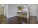 Open concept kitchen with wood cabinets, white appliances, and dark brown flooring at 809 Andrea Ln, Hanahan, SC 29410