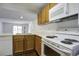 Modern kitchen with white appliances and wood cabinets, and a view of the living room at 809 Andrea Ln, Hanahan, SC 29410