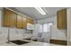 Modern kitchen with white appliances, wood cabinets, and quartz countertops at 809 Andrea Ln, Hanahan, SC 29410