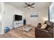 Cozy living room with a brown leather couch and large TV at 207 Shortmarsh St, Summerville, SC 29486