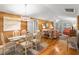 Bright dining area with glass table and white chairs, hardwood floors at 1101 Summerwind Ln, Seabrook Island, SC 29455