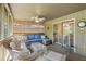 Large screened porch with comfortable seating and a view of the surrounding trees at 1101 Summerwind Ln, Seabrook Island, SC 29455
