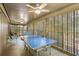 Screened porch with ping pong table, ceiling fan, and ample seating at 1101 Summerwind Ln, Seabrook Island, SC 29455