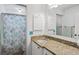 Bathroom with granite vanity, shower/tub combo, and coastal decor at 1101 Summerwind Ln, Seabrook Island, SC 29455