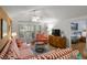 Living room with striped couches, access to bedroom and patio at 1101 Summerwind Ln, Seabrook Island, SC 29455