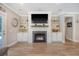 Modern fireplace with built-in shelving and a large flat-screen TV above the mantle at 1010 Deep Gap Rd, Ridgeville, SC 29472