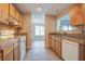 Kitchen with wood cabinets, tiled floors, and white appliances at 607 Waterwood Dr, Goose Creek, SC 29445