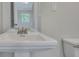 Bathroom with pedestal sink and view of toilet and more at 1910 Kerry St, North Charleston, SC 29406