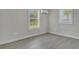 Spacious bedroom with wood-look floors and two windows at 1910 Kerry St, North Charleston, SC 29406