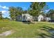 Side view of a charming bungalow, showcasing the landscaping and yard at 1910 Kerry St, North Charleston, SC 29406