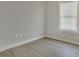Simple bedroom with wood-look floors and large window at 1910 Kerry St, North Charleston, SC 29406