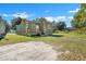 Rear view of a small house with green siding and wooden deck at 1910 Kerry St, North Charleston, SC 29406