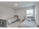 Bright bedroom featuring two twin beds with striped bedding at 229 Camellia Bloom Dr, Moncks Corner, SC 29461