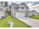 Two-story house with gray siding, white columns, and a two-car garage at 229 Camellia Bloom Dr, Moncks Corner, SC 29461