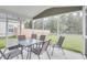 Screened porch with seating for six at 229 Camellia Bloom Dr, Moncks Corner, SC 29461