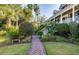 Brick pathway leading to home with tropical plants at 1311 S Jenkins Lagoon Dr, Seabrook Island, SC 29455