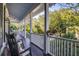 Relaxing porch with rocking chairs and lush greenery views at 1311 S Jenkins Lagoon Dr, Seabrook Island, SC 29455