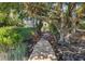 Wooden boardwalk path winds through lush landscaping toward a home at 1311 S Jenkins Lagoon Dr, Seabrook Island, SC 29455