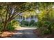 House with wrap around porch and mature trees at 1311 S Jenkins Lagoon Dr, Seabrook Island, SC 29455