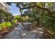 Charming flagstone patio with seating area nestled amongst lush landscaping at 1311 S Jenkins Lagoon Dr, Seabrook Island, SC 29455
