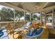 Spacious screened porch with seating and outdoor dining at 1311 S Jenkins Lagoon Dr, Seabrook Island, SC 29455