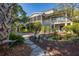 Two-story home with screened porch and landscaped backyard at 1311 S Jenkins Lagoon Dr, Seabrook Island, SC 29455