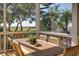Enjoy tranquil marsh views from this screened porch, complete with a dining setting at 1311 S Jenkins Lagoon Dr, Seabrook Island, SC 29455