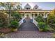 Grand home entrance with brick stairs and landscaping at 1311 S Jenkins Lagoon Dr, Seabrook Island, SC 29455