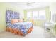 Bedroom with a queen bed and wicker chair at 1311 S Jenkins Lagoon Dr, Seabrook Island, SC 29455