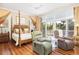 Main bedroom with hardwood floors and access to balcony at 1311 S Jenkins Lagoon Dr, Seabrook Island, SC 29455