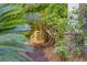 Secluded garden path with arbor gate, lush foliage, and pine straw at 1311 S Jenkins Lagoon Dr, Seabrook Island, SC 29455