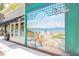 Exterior wall art depicting a beach scene, adding charm to a Freshfields Village shop at 1311 S Jenkins Lagoon Dr, Seabrook Island, SC 29455
